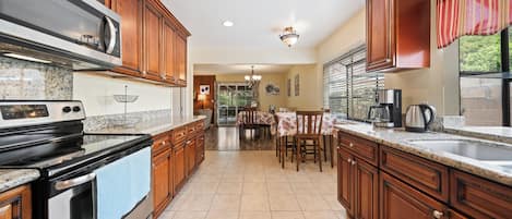 A coffee maker, toaster, knife set, pots and pans, dishes, wine glasses, etc.