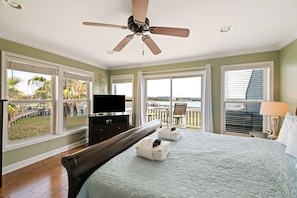 Main bedroom upstairs featuring a King bed, TV and ensuite bathroom.