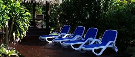 Sun loungers by the gazebo and pool