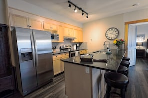 New stainless steel appliances, whisper quiet dishwasher and sitting area.