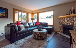 Cozy up to the River Stone Fireplace or watch the 55" TV on the sectional sofa. 