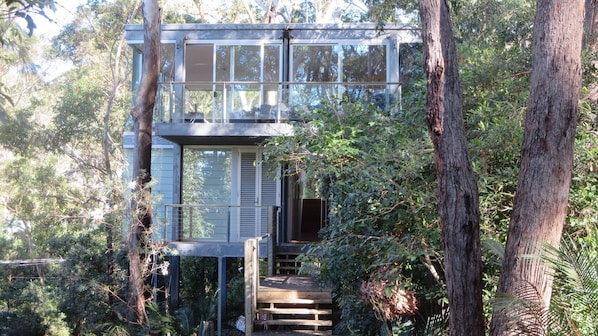 House sits among the gum trees.