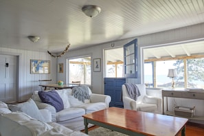 Living area with windows for the view and an open dutch door for fresh ocean air
