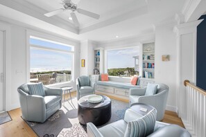Large living area with HDTV and sitting area with window seat and more views!