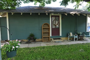 Cottage overlooks half acre back yard with hammock, table, chairs  and fire pit 