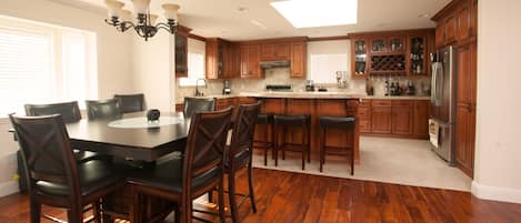 Spacious and elegant, open-concept kitchen with a large eat-in island 