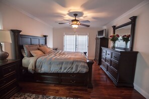 Cozy master bdrm with recessed lights on a dimmer panel and French doors 