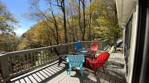 Large upper deck has plenty of chairs, fire pit, and a gas grill.