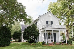 Main House exterior with covered brick patio