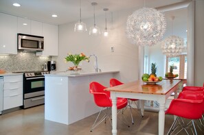 Open kitchen dining area with a mix of eclectic furnishings