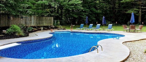 Come relax outside near the custom saltwater pool and fenced in backyard!