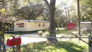 Fenced yard, covered carport for car.