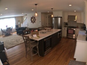Kitchen, gas stove, range hood vented outside, dishwasher, microwave, beverage