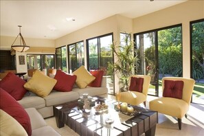 great room with walls of glass featuring a garden