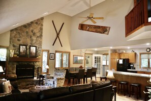 View of open living/dining/kitchen area from front door looking toward foyer. 