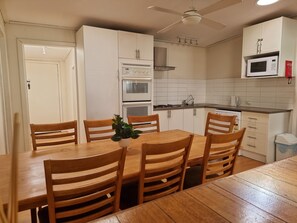 The kitchen is equipped with cooking equipment, utensils and crockery.