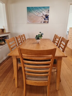 There is a dining table for morning breakfast or dinner after a day at the beach