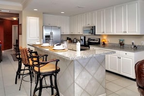 High end appliances in the kitchen and a breakfast bar too!
