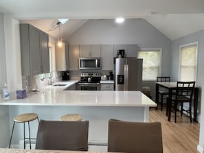 Brand new kitchen with stainless & quartz.