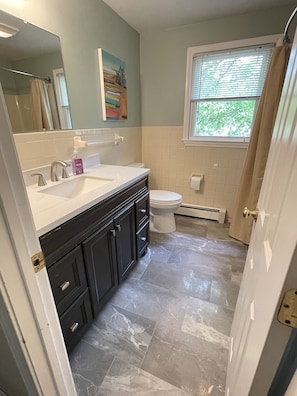 New updated bathrooms with marble floors & vanity.