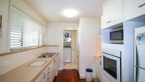 Kitchen leading on to laundry and second toilet and shower