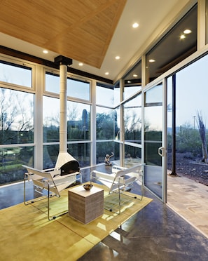 Recessed lighting throughout, sliding doors leading to one of two stone decks 