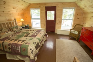 Lake House master bedroom with queen sized Adirondack bed and water view.