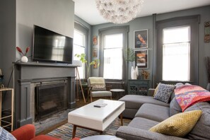 Primary living room with large Smart TV and sofa bed