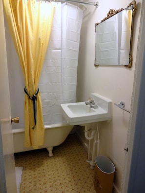 Charming bath with large claw footed tub / shower.