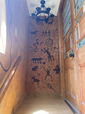 Entrance walking up the stairs to your Upstairs  Cottage painted with tribal art