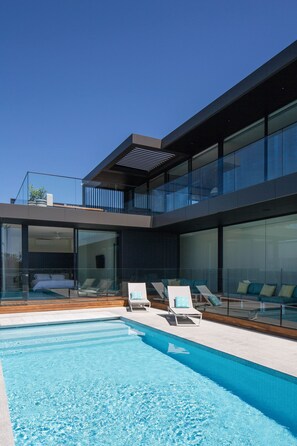 View of the heated pool, large upstairs terrace & master bedroom