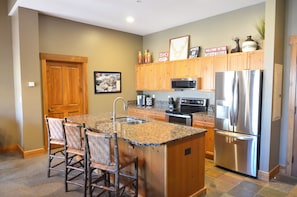 Kitchen with 8 ft island, granite counters and plenty of room for food prep