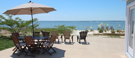 Deck surrounded by the water and your own private sandy beach