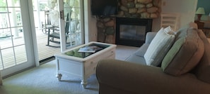 Living room w/ stone gas fireplace