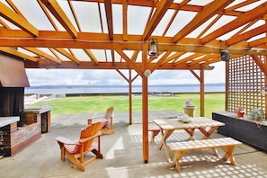 Expansive Lanai with massive wood burning fireplace, BBQ and dining area.