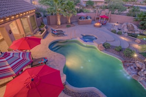 Private backyard has exciting resort amenities that include a heated pool, spa, putting green, basketball hoop, fire pit, fireplace and more.