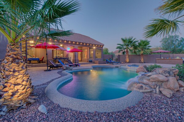 Enjoy the glow and warmth from the gas fire pit or wood burning fireplace in the backyard paradise at MESA DESERT OASIS.