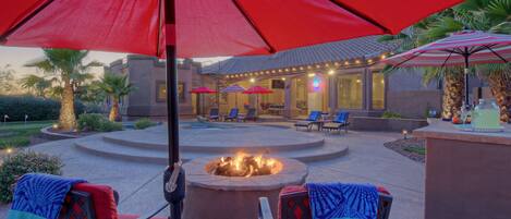 Enjoy the glow and warmth from the gas fire pit or wood burning fireplace in the backyard paradise at MESA DESERT OASIS.