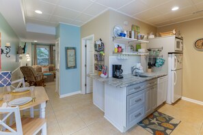 View from the front door, kitchen on the right, bedroom/sitting area straight ahead.