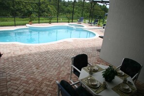 Enjoy your meals under the Lanai. Over head Fan (shown without fence)