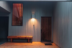 Front porch with sitting bench next to the carport