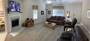 Cozy Living area with leather couch and recliners.  Gas fireplace and 48" TV