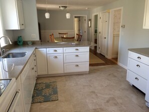 New kitchen opens to the dining room.  Quartz counters, tile floor.