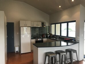 Kitchen with bifold windows onto deck