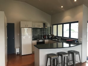 Kitchen with bifold windows onto deck