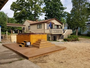 Cottage home on Campau Lake with swim pool spa, deck 8 burner gas grill, dock, firepit, volleyball and transportation with conseierge app Dezz and our Airbnb progressive dinner package. House next door options Campau Heaven 4 story 9 bedroom options.