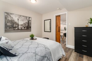 Second bedroom complete with dresser and mirror.