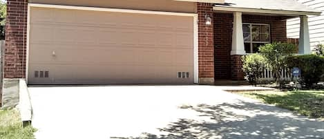 Two storey home with parking for two vehicles on the driveway.