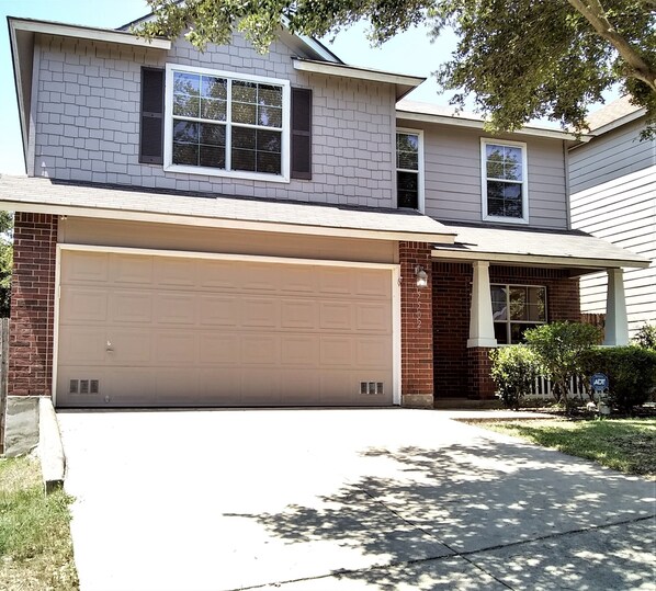 Two storey home with parking for two vehicles on the driveway.