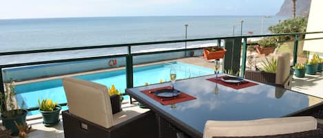 Private balcony with garden furniture over the pool and sea view